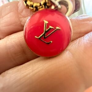 Louie Vuitton Gold tone Monogram Pink 
Enamel Charm on GP stainless
rolo chain